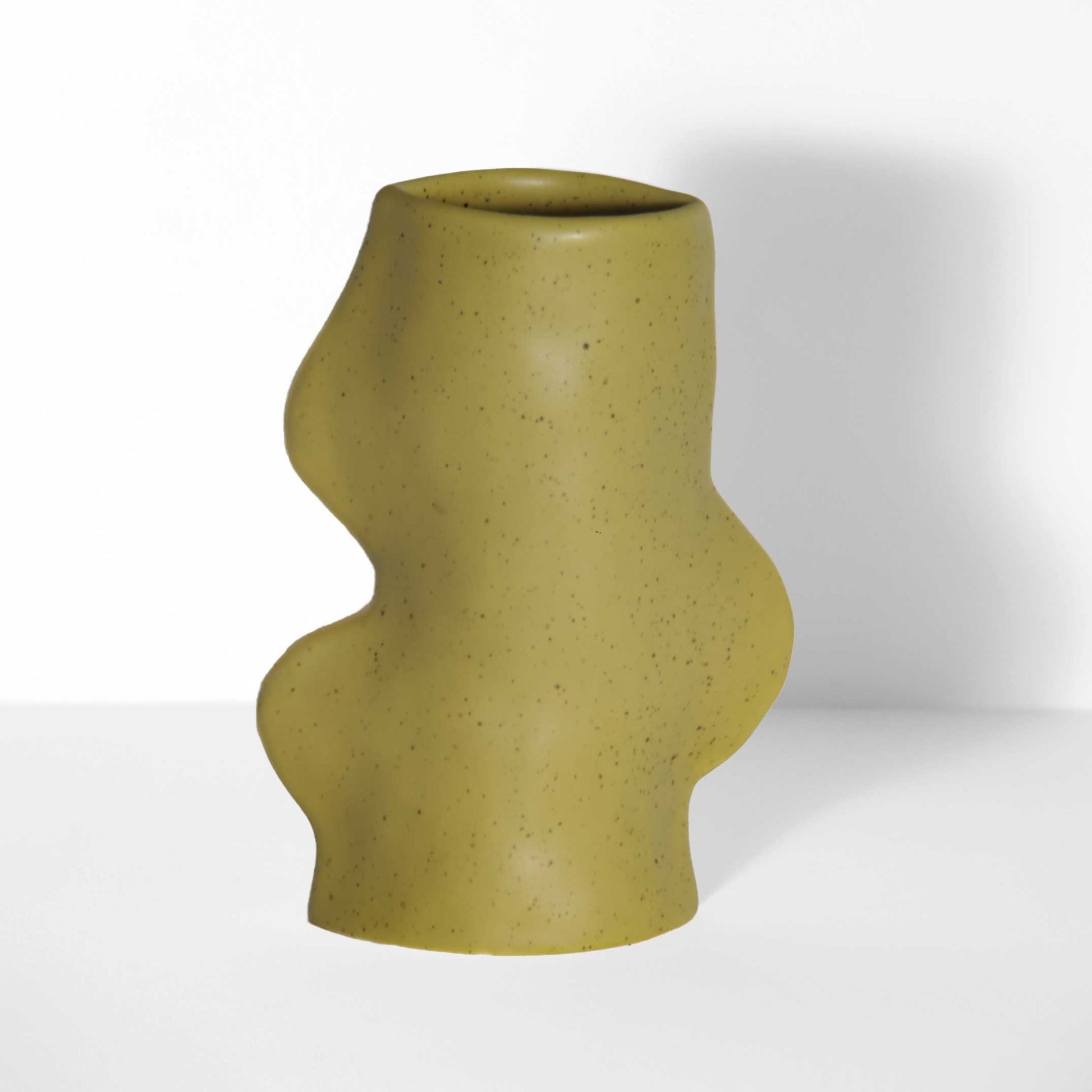 ceramic vase in pistachio green with flowing sculptural design