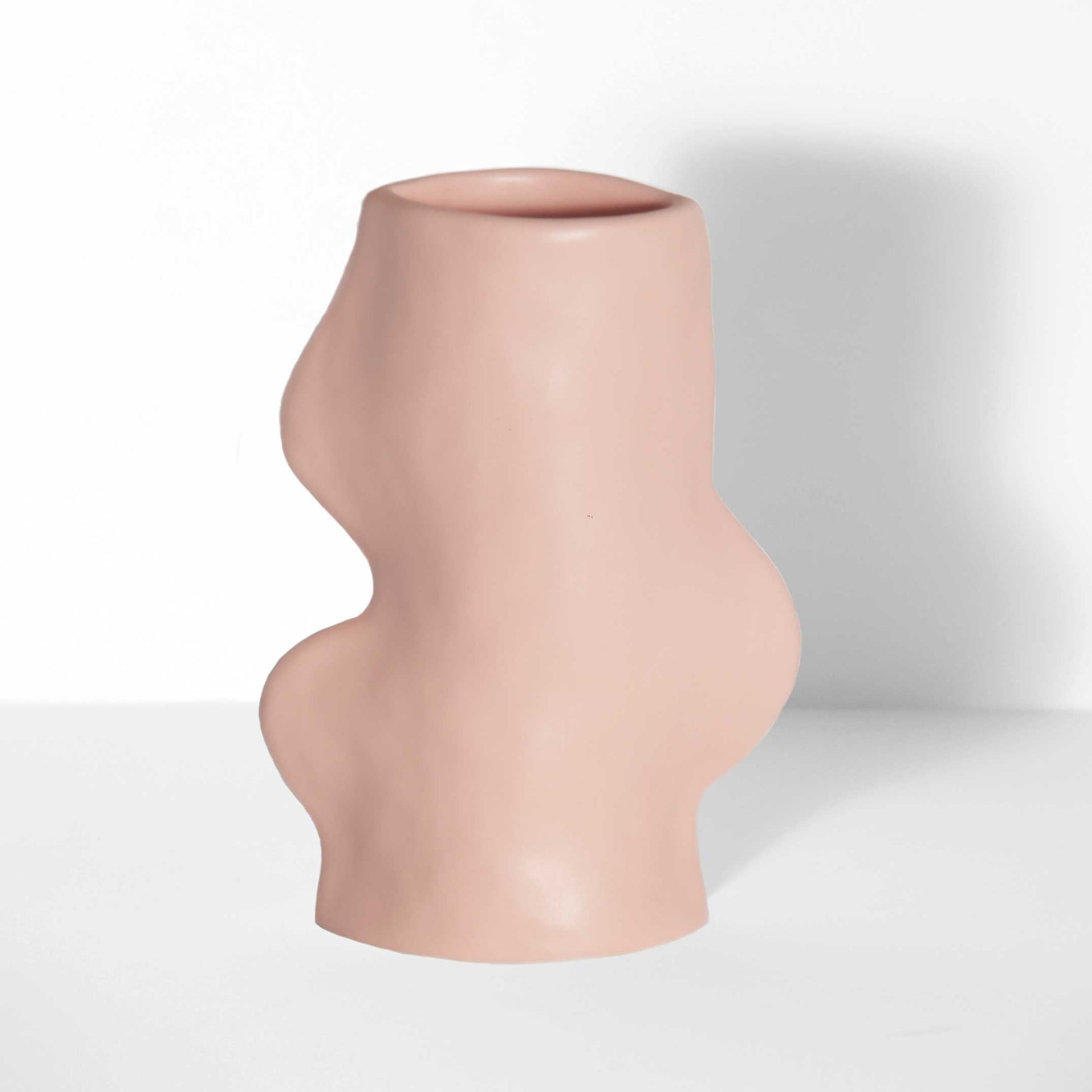 handmade ceramic vase in pink with flowing sculptural design