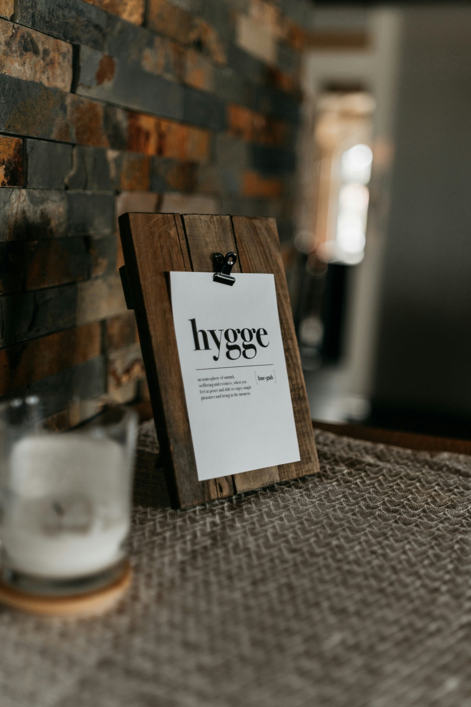 Wooden frame with hygge text in a cozy Scandinavian interior