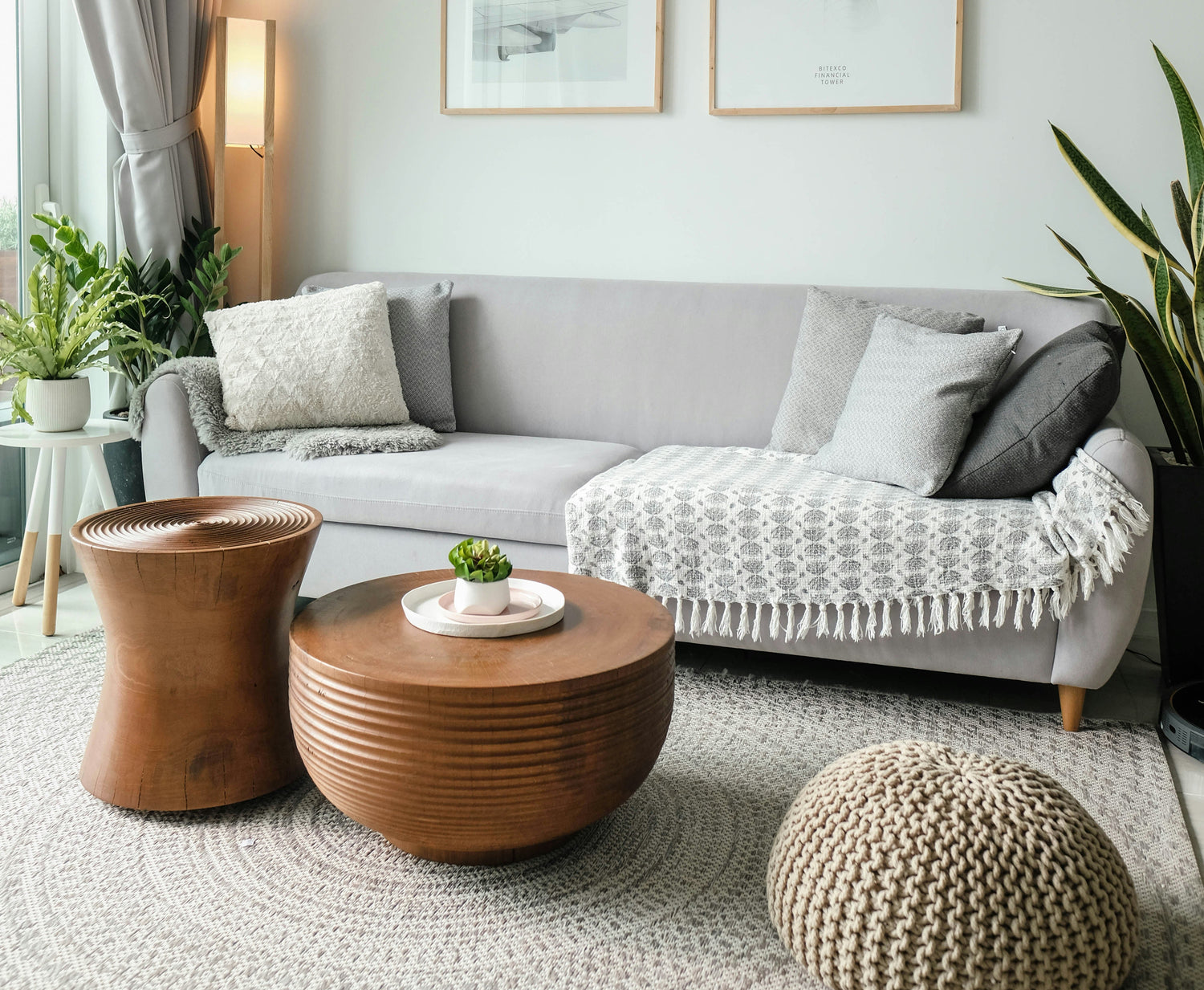 A living room interior with neutral furniture, natural textures, and soft daylight.