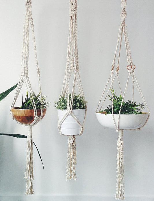 handmade macrame plant hanger made of cotton rope for indoor plant display