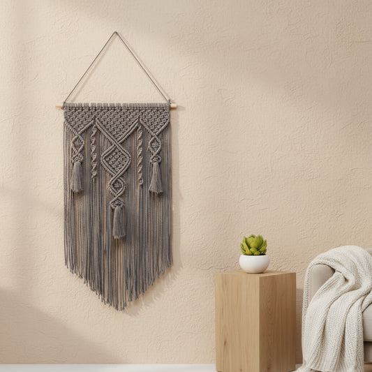 handwoven macrame wall hanging made from cotton rope with wooden support