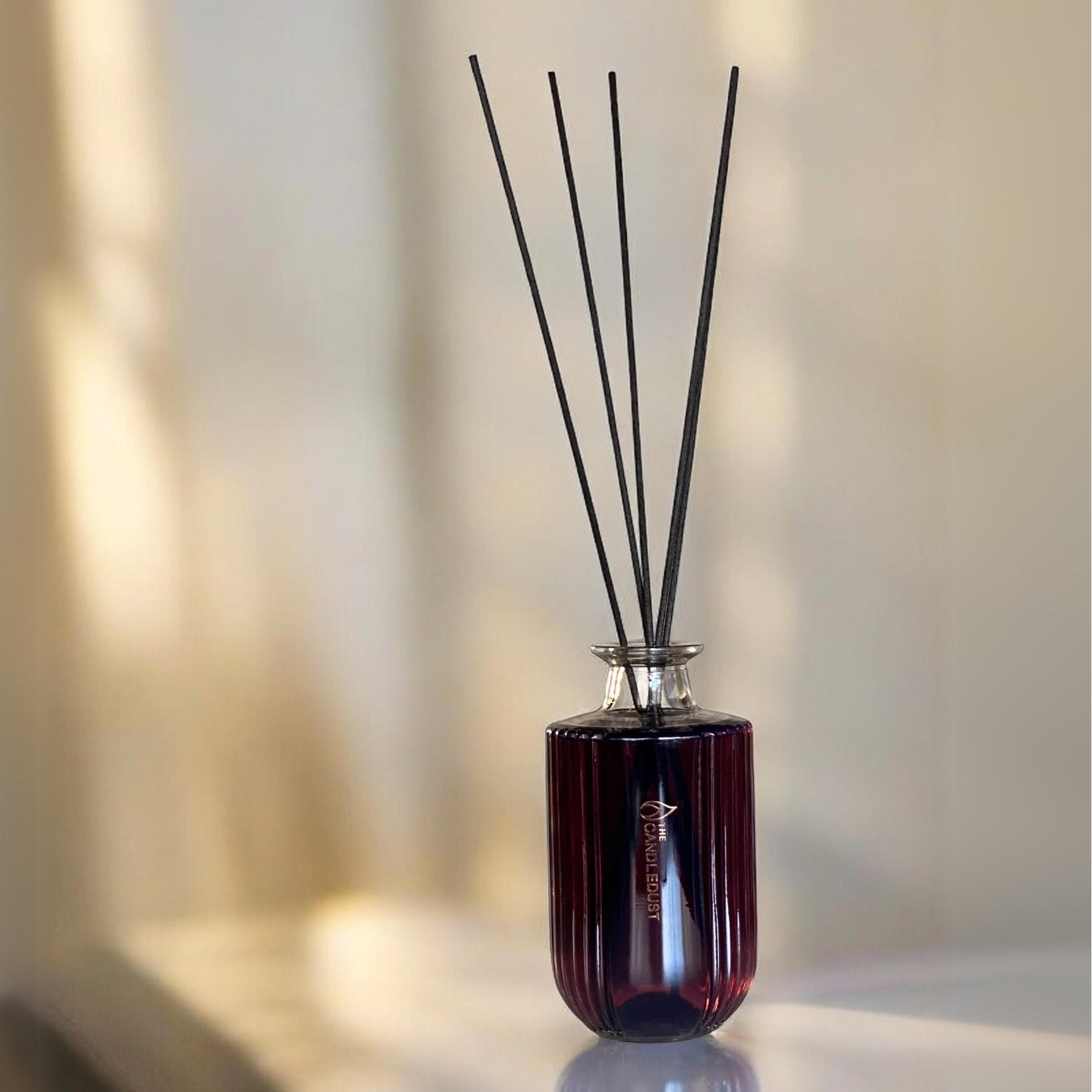 room diffuser with berry and warm notes and reed sticks
