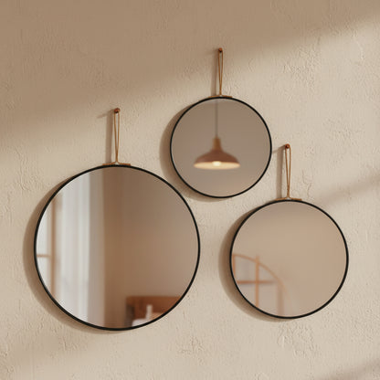 set of round wall mirrors in different sizes arranged together