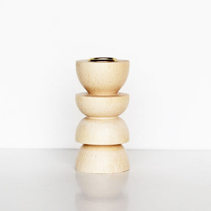 wooden candle holder with sculptural shape and brass insert